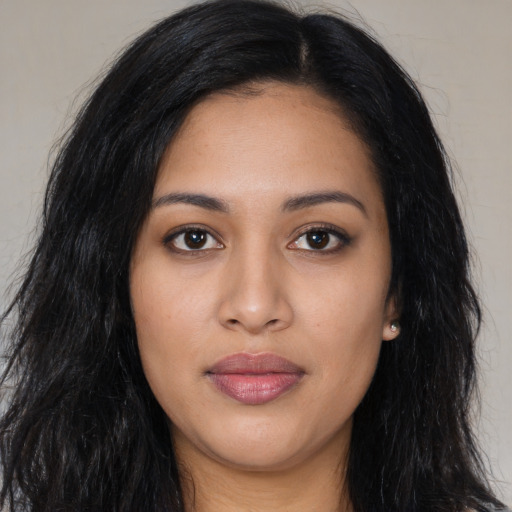 Joyful latino young-adult female with long  black hair and brown eyes