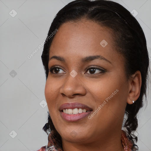 Joyful black young-adult female with medium  black hair and brown eyes