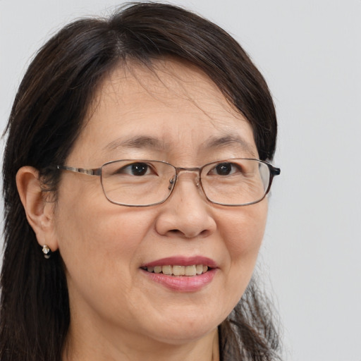 Joyful white adult female with long  brown hair and brown eyes