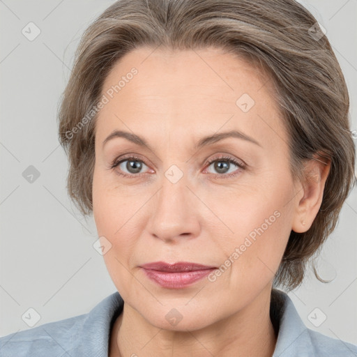 Joyful white adult female with medium  brown hair and grey eyes