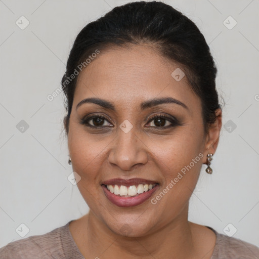 Joyful latino young-adult female with short  brown hair and brown eyes