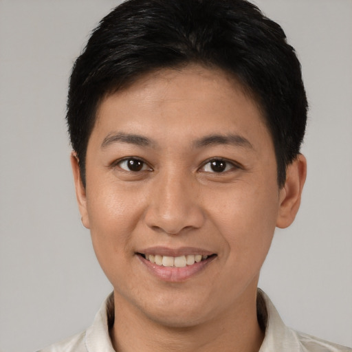 Joyful white young-adult female with short  black hair and brown eyes