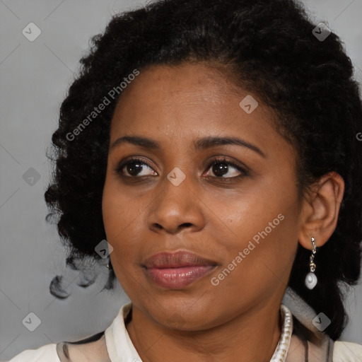 Joyful black young-adult female with medium  brown hair and brown eyes