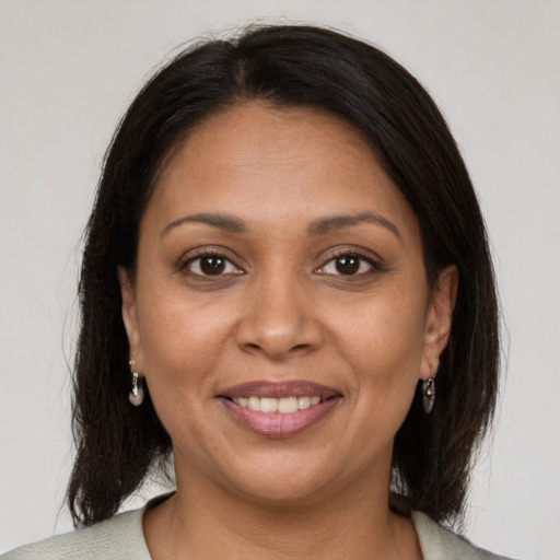 Joyful black young-adult female with medium  brown hair and brown eyes