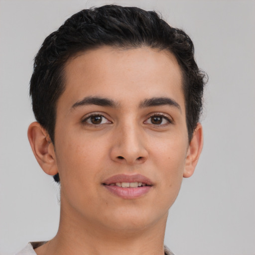Joyful latino young-adult male with short  brown hair and brown eyes