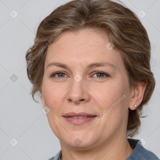 Joyful white adult female with medium  brown hair and blue eyes