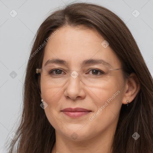 Joyful white adult female with long  brown hair and brown eyes