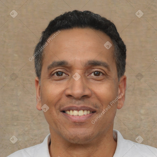 Joyful latino adult male with short  black hair and brown eyes