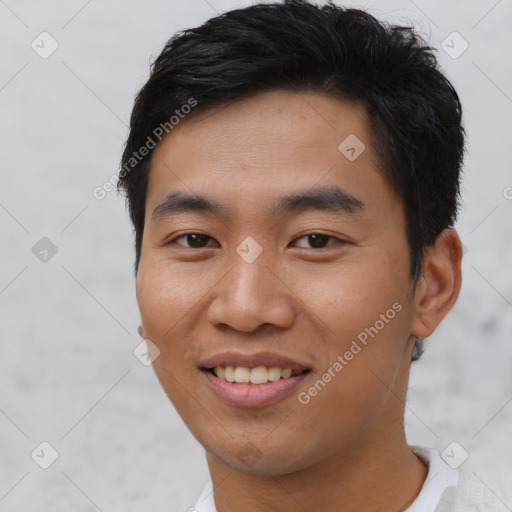 Joyful asian young-adult male with short  brown hair and brown eyes