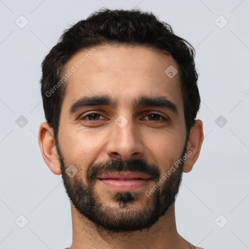 Joyful white young-adult male with short  black hair and brown eyes