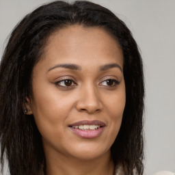 Joyful latino young-adult female with long  brown hair and brown eyes