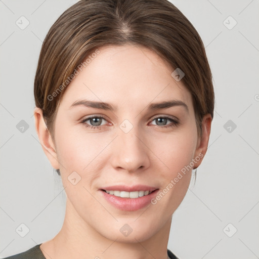 Joyful white young-adult female with short  brown hair and grey eyes