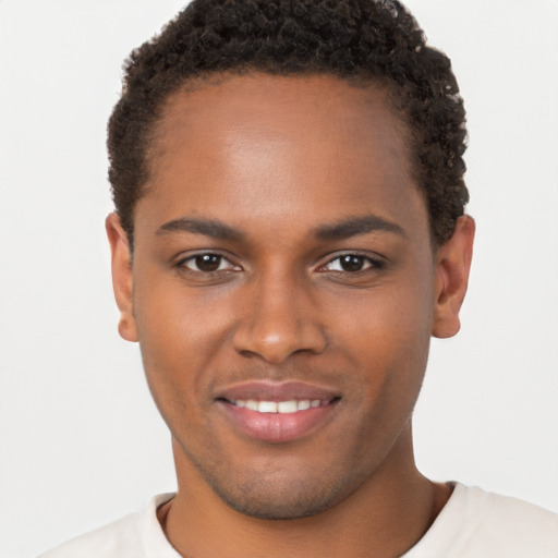 Joyful black young-adult male with short  brown hair and brown eyes