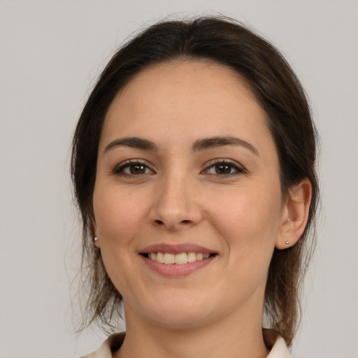 Joyful white young-adult female with medium  brown hair and brown eyes