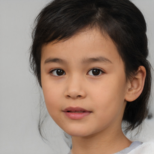 Joyful asian child female with medium  brown hair and brown eyes