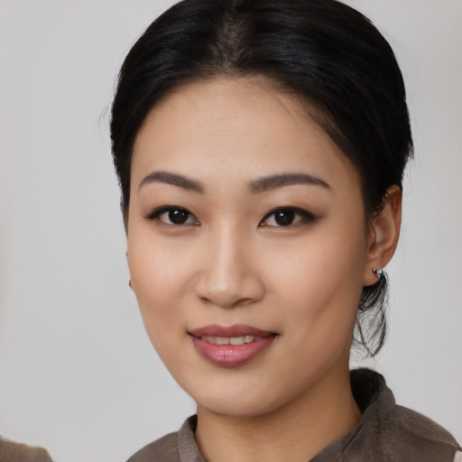 Joyful asian young-adult female with medium  black hair and brown eyes