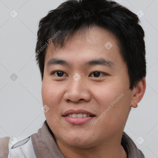 Joyful asian young-adult male with short  brown hair and brown eyes