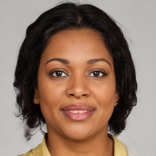 Joyful black young-adult female with medium  brown hair and brown eyes