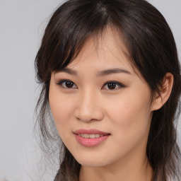 Joyful asian young-adult female with long  brown hair and brown eyes