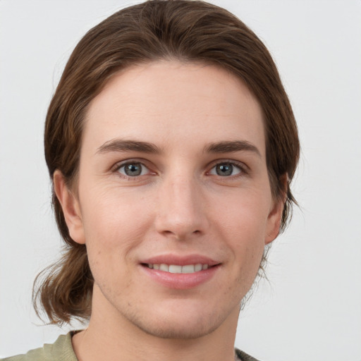 Joyful white young-adult female with medium  brown hair and grey eyes