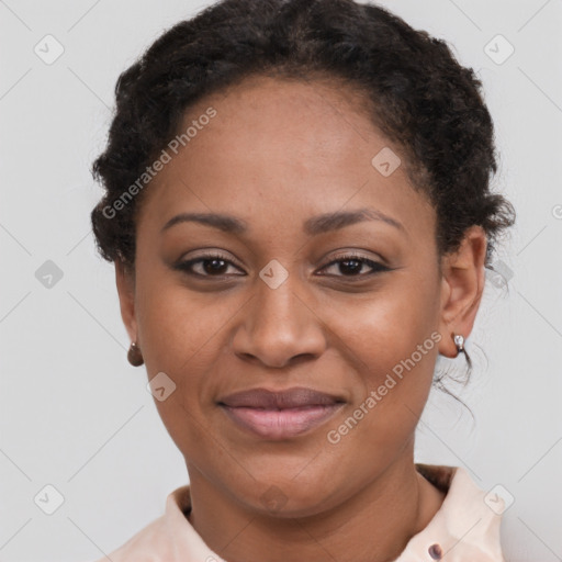 Joyful black adult female with short  brown hair and brown eyes