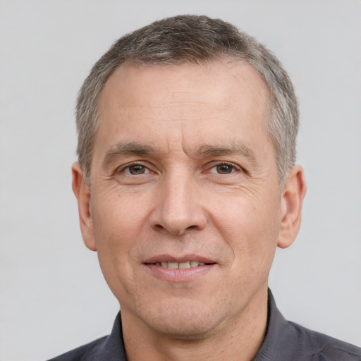 Joyful white adult male with short  brown hair and brown eyes