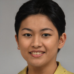 Joyful asian young-adult female with short  brown hair and brown eyes