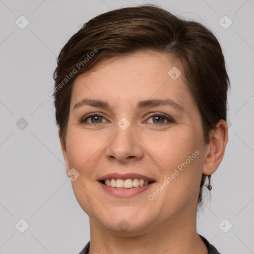 Joyful white young-adult female with short  brown hair and grey eyes