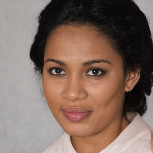 Joyful black adult female with medium  black hair and brown eyes