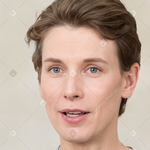 Joyful white young-adult female with short  brown hair and grey eyes