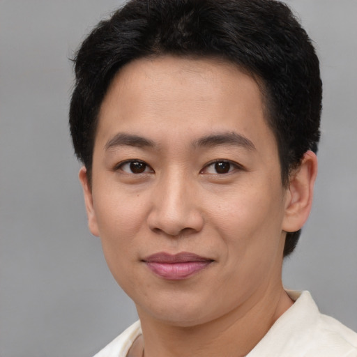 Joyful asian young-adult male with short  brown hair and brown eyes