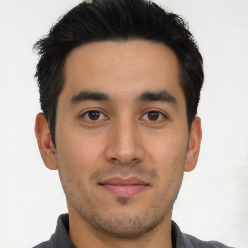 Joyful latino young-adult male with short  brown hair and brown eyes
