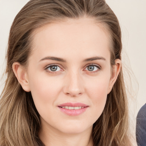 Joyful white young-adult female with long  brown hair and blue eyes