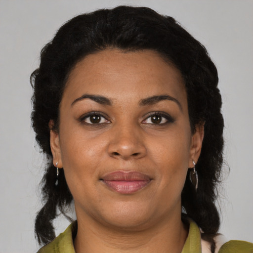 Joyful black young-adult female with medium  brown hair and brown eyes