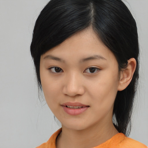 Joyful asian young-adult female with medium  black hair and brown eyes