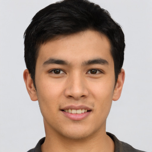 Joyful asian young-adult male with short  brown hair and brown eyes
