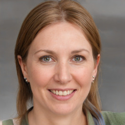 Joyful white young-adult female with medium  brown hair and blue eyes