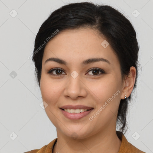 Joyful latino young-adult female with medium  brown hair and brown eyes