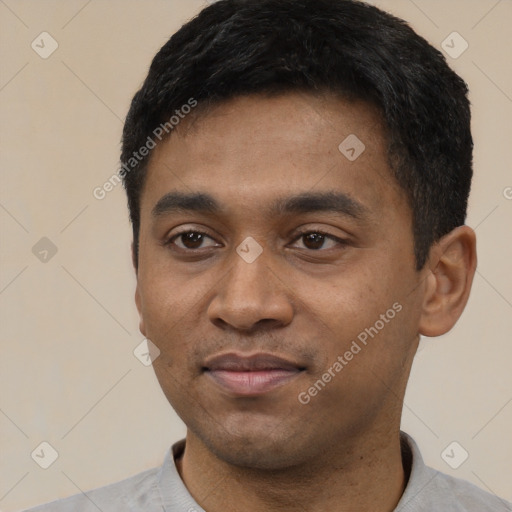 Joyful latino young-adult male with short  black hair and brown eyes