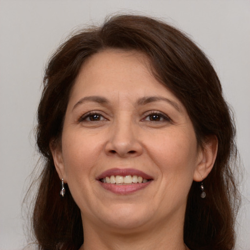 Joyful white adult female with medium  brown hair and brown eyes