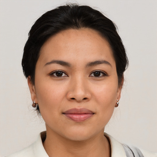 Joyful asian young-adult female with medium  brown hair and brown eyes