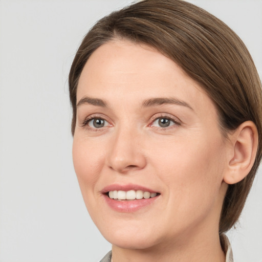 Joyful white young-adult female with medium  brown hair and brown eyes