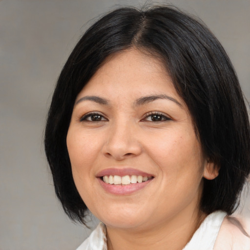 Joyful asian young-adult female with medium  brown hair and brown eyes