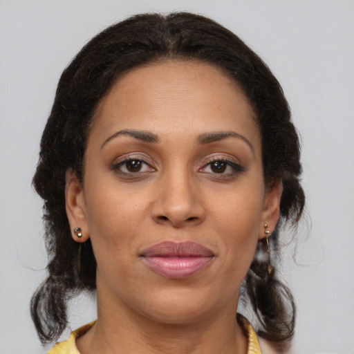 Joyful latino adult female with medium  brown hair and brown eyes