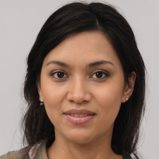 Joyful latino young-adult female with medium  brown hair and brown eyes