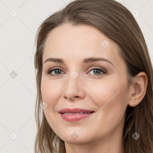 Joyful white young-adult female with long  brown hair and grey eyes