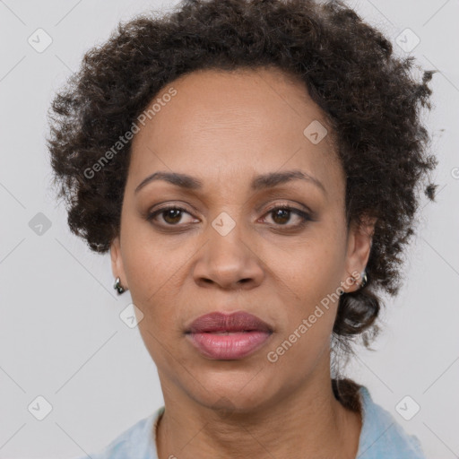 Joyful black adult female with short  brown hair and brown eyes