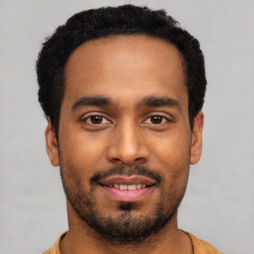Joyful latino young-adult male with short  black hair and brown eyes