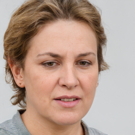 Joyful white adult female with medium  brown hair and blue eyes