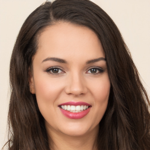 Joyful white young-adult female with long  brown hair and brown eyes